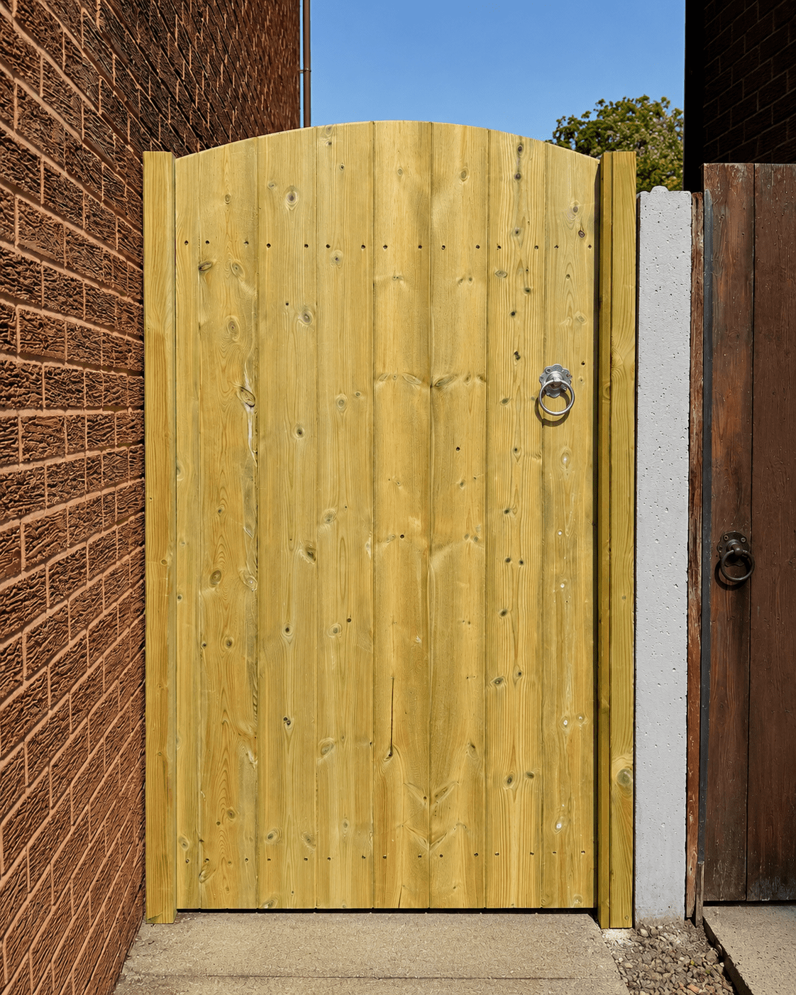 Curved top style timber side gate installed by The Side Gate Company