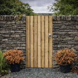 Timber side gate installed between stone walls in the North West UK